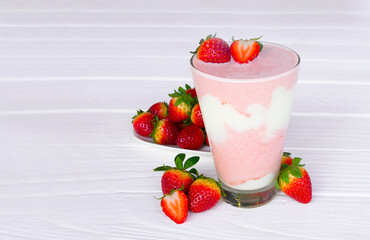 Strawberry yogurt fruit juice smoothie pink colorful fruit juice milkshake blend beverage healthy high protein the taste yummy In glass drink episode morning on white wood background.