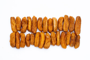 Sun-dried bananas on white background.