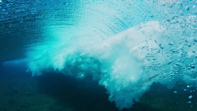 Ocean wave. Crystal clear ocean wave rolls and breaks. Indian Ocean's wave breaking on the Maldivian shore during bright sunny day
