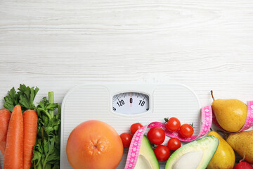 Flat lay composition with scales and healthy food on white wooden table, space for text