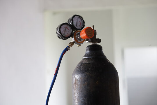 oxygen cylinder with pressure gauge and hose installed and ready to use