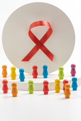 Humanoid doll with red ribbon on white background