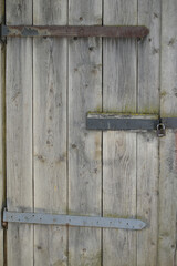 Old rustic wooden door and metal padlock