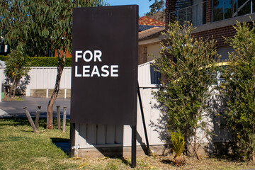 For lease sign on a black display outside of a resedential building in Australia. Investment...