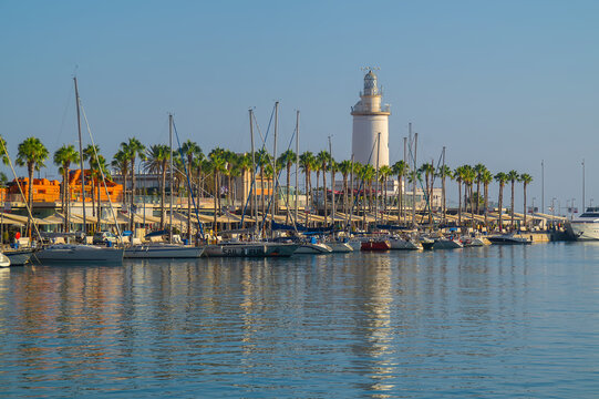 Farola de Malaga surrounded by boats and the sea on a sunny day in Spain