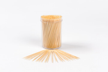 Wooden toothpicks and holder on white background