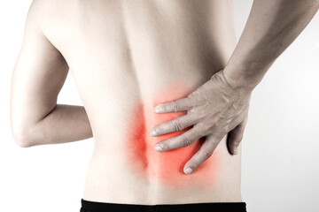 A man presses his hand against his back, has back pain and bone pain.