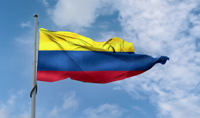 Columbian flag waving on a pole in a blue sky