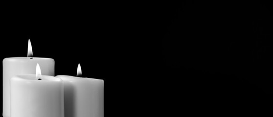 set of candles with flama, space for text, black and white.