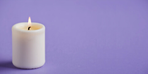Fototapeta na wymiar candle with flame, violet background space for text