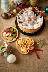 Christmas cake and biscuit on rustic background