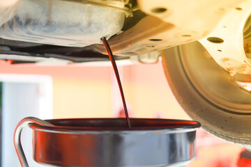 pouring engine oil into a cup
