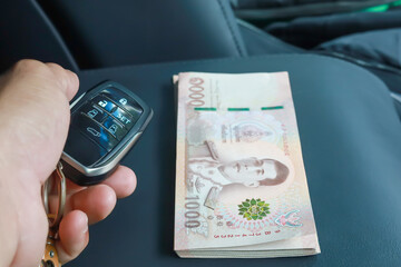 hand holding key and money