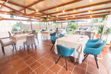 Tables arranged and ready for use in hotel dining room.