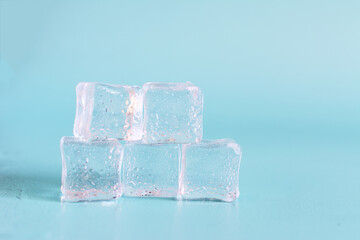 Transparent ice cubes with water drops on a light background close-up. Background of transparent ice cubes close-up and.