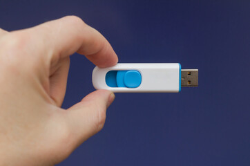 pc flash drive in hand on purple blue background