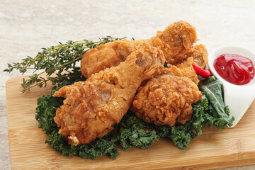 Fried chicken drumsticks with tomato sauce