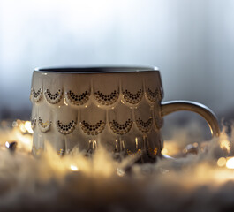 Beautiful cup on a blurred background in the dark with garlands.
