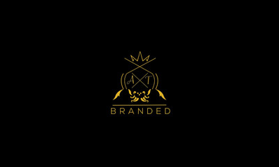 AT is a branded luxury logo with golden color and black background.