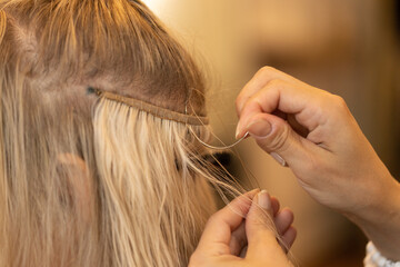 Closeup shot of the process of doing a hair extension