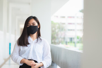 close up attractive adult business woman wearing face mask in office.