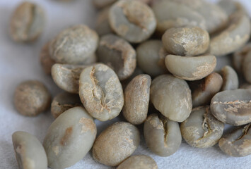 Fototapeta na wymiar Close up view of roasted arabica coffee beans on a blurred coffee background