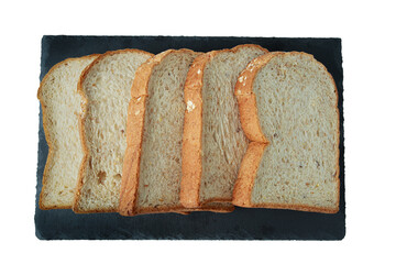 selective focus of pile of toasted bread slices on a single black plate. On pure white background.