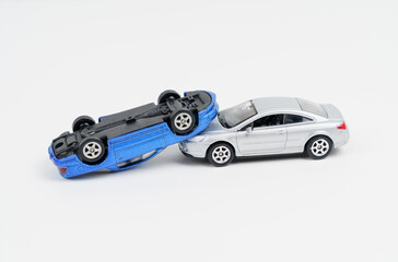 Collision of silver and blue toy cars. Isolated on white background.