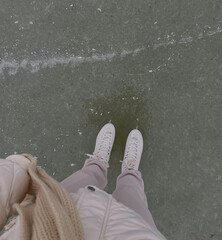 A girl skates on a frozen lake.