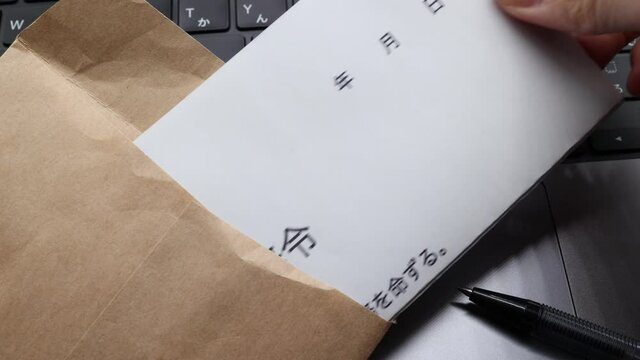転勤辞令　封筒から出す