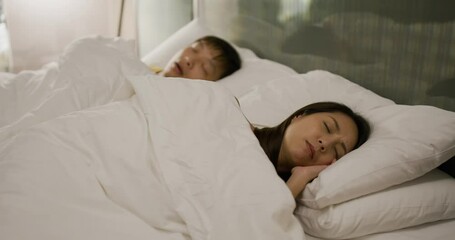 Woman suffer from her husband snore on bed