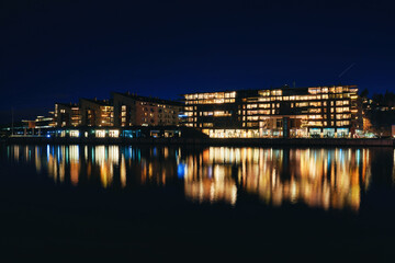 Lysaker Brygge by night. Long exposure to smooth out the water and to capture the dark parts without noise. Shot at Oslo, Norway, from the Bygdøy side Sollerud boat building. 