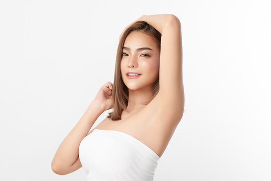 Beautiful Young Asian woman lifting hands up to show off clean and hygienic armpits or underarms on white background, Smooth armpit cleanliness and protection concept