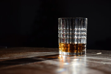 A glass of golden whiskey with afternoon sunlight highlighting the liquor colour