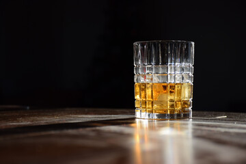 A glass of golden whiskey with afternoon sunlight highlighting the liquor colour