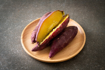 Grilled or baked Japanese sweet potatoes on wood plate