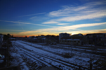 Railway with snow, under sunset blue light