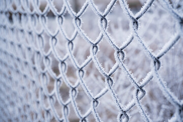 Frost on a metal grid against a winter background.