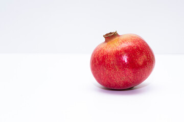 Red ripe pomegranate, fruit on a white background. Isolated item and copy space.