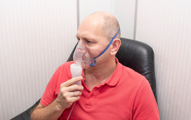 A middle-aged Kavaz man does respiratory tract prophylaxis, therapeutic inhalation.