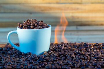 Coffee cup on a background of wood and fire