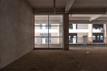 Unfinished concrete interior space and glass windows