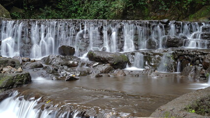 Curug Putri waterfall photographed with slow speed photography, flowing water looks like cotton in Kuningan Regency, West Java, Indonesia.