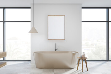 Fototapeta na wymiar Bright bathroom interior with bathtub, empty white poster, panoramic window