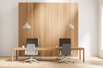 Bright office room interior with four desktops, comfortable armchairs
