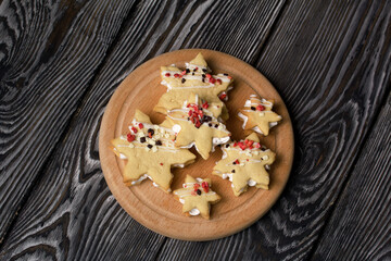 Marshmallow sandwiches decorated with chocolate and freeze-dried strawberries. Lie on a round wooden board. Close-up shot.