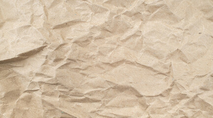 Recycled brown creased paper background from a paper packing. Crumpled brown paper texture concept