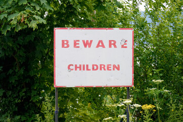 Beware children safety sign on road for drivers