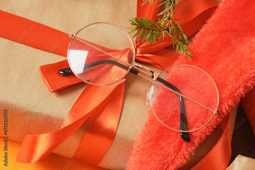 Wall mural beatiful trendy eye glasses on gift box with red ribbon, christmas optic store sale