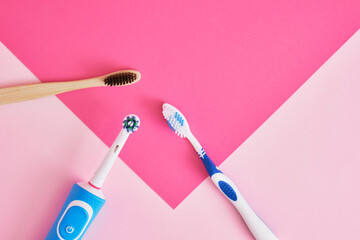 several different types of toothbrushes on a pink background